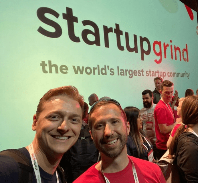 two software industry professionals taking a selfie at startup event